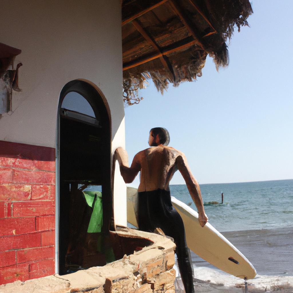 Man surfing at beach house